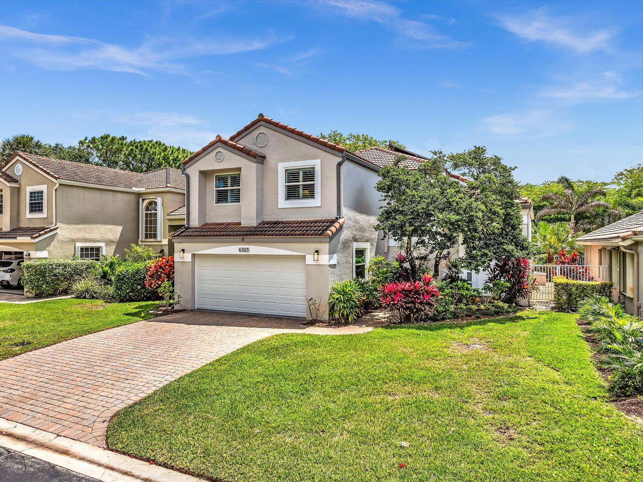 6307 Via Palladium Boca Raton, FL 33433 - Photo 1 of 85 a front view of a house with a yard and garage
