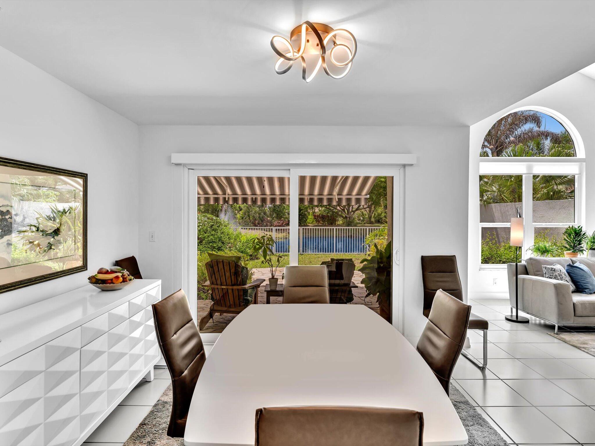6307 Via Palladium Boca Raton, FL 33433 - Photo 27 of 85 a view of a dining room with furniture a fireplace and wooden floor
