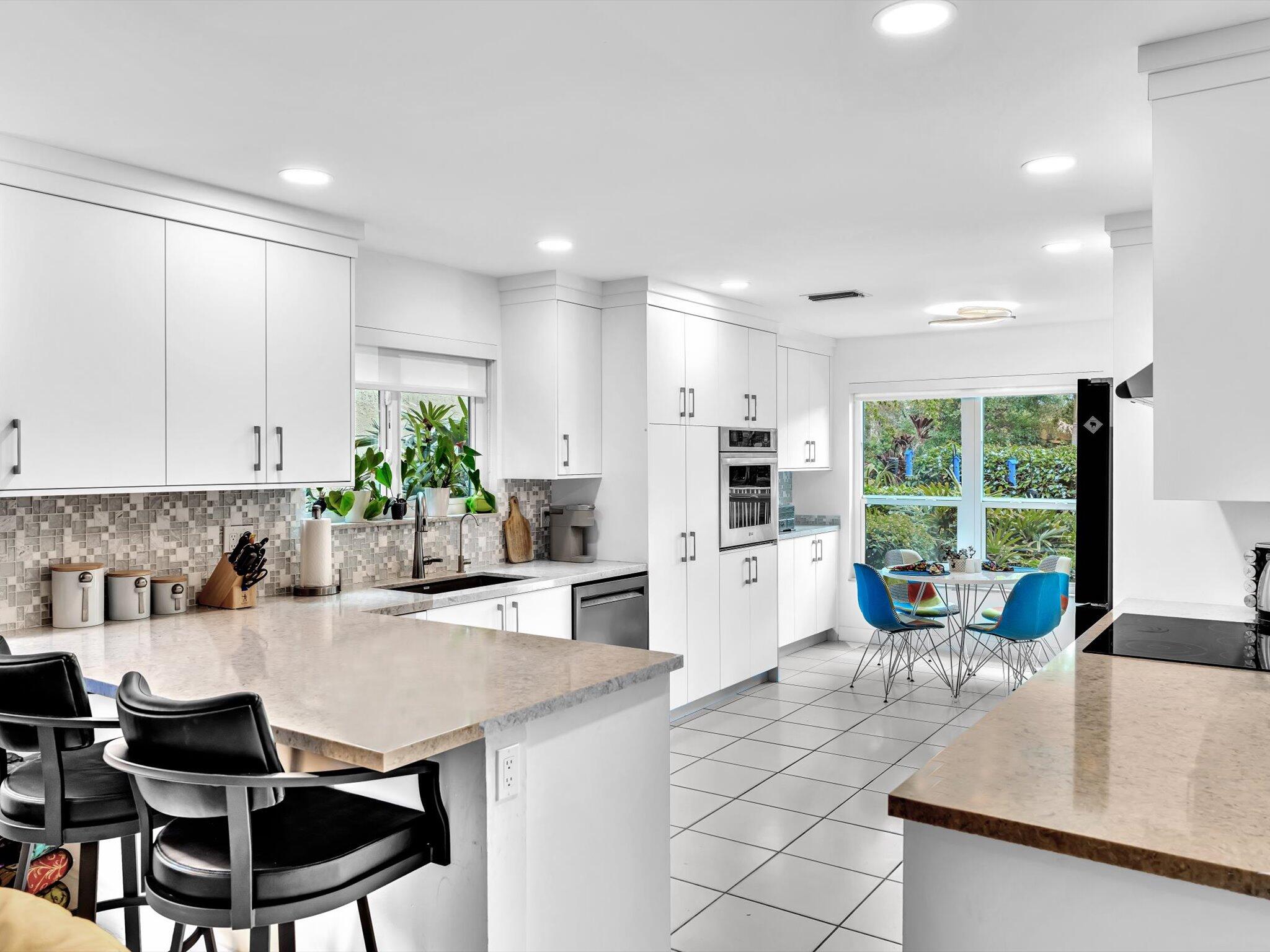 6307 Via Palladium Boca Raton, FL 33433 - Photo 33 of 85 a kitchen with stainless steel appliances kitchen island granite countertop a sink and cabinets