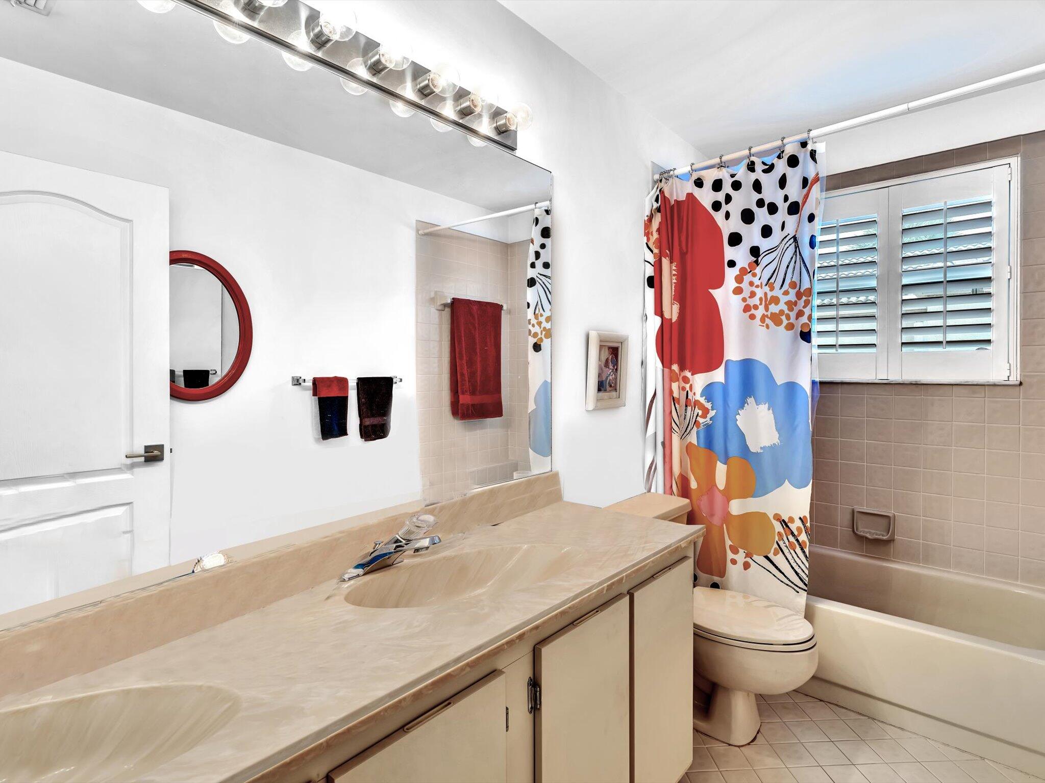 6307 Via Palladium Boca Raton, FL 33433 - Photo 59 of 85 a bathroom with a sink a toilet and shower curtain
