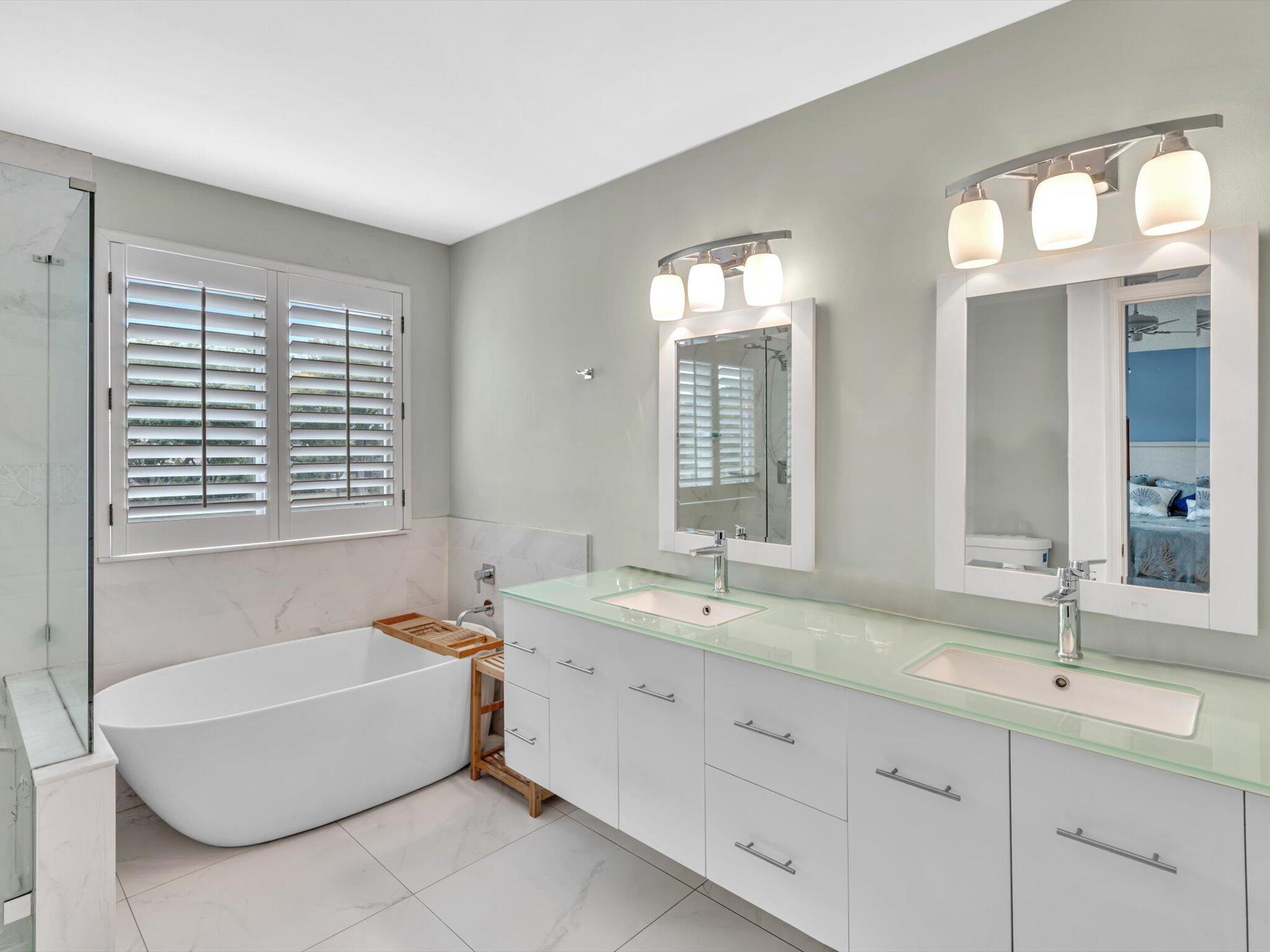 6307 Via Palladium Boca Raton, FL 33433 - Photo 7 of 85 a spacious bathroom with double vanity a mirror a bathtub and a shower