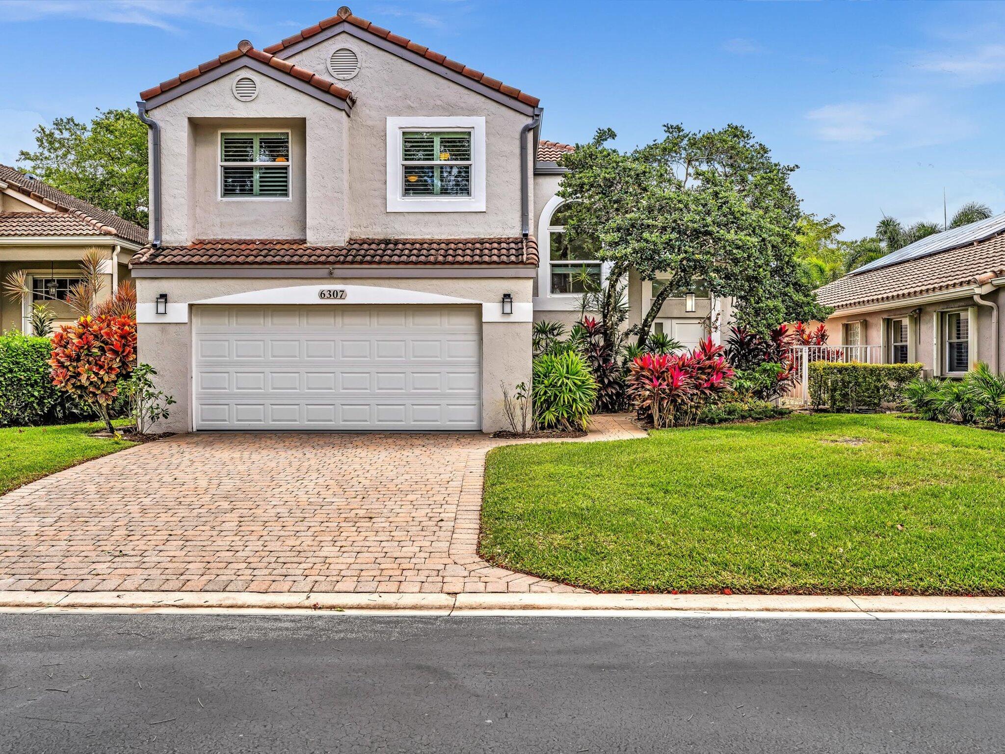 6307 Via Palladium Boca Raton, FL 33433 - Photo 8 of 85 a front view of a house with a garden