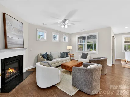 a living room with furniture a fireplace and a window