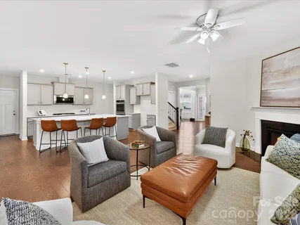a living room with furniture and kitchen view