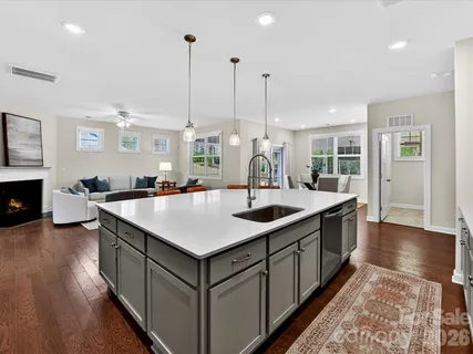 a kitchen with counter top space and wooden floor