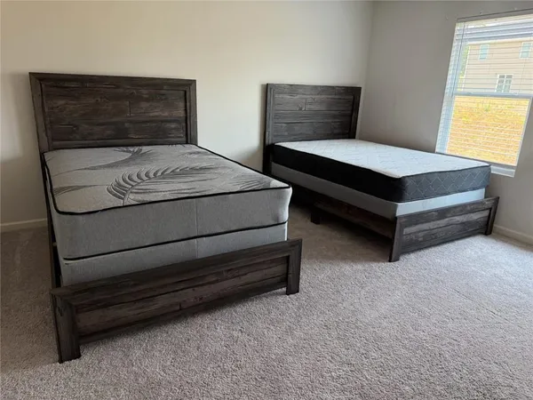 a bedroom with a bed and window