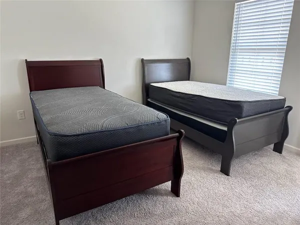 a bedroom with a bed and window