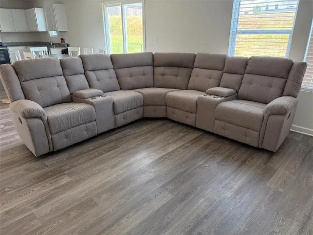 a living room with furniture and a wooden floor