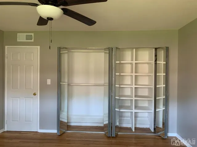 a view of a room with wooden floor