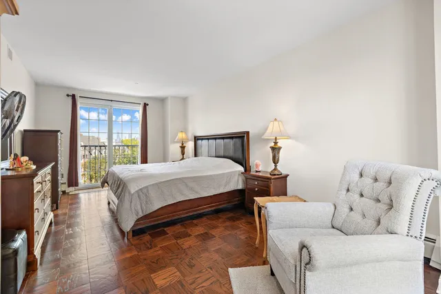 a bedroom with a bed couch and a window