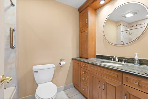 a bathroom with a toilet sink and mirror