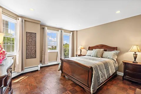 a bedroom with a bed and glass door
