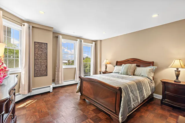a bedroom with a bed and glass door