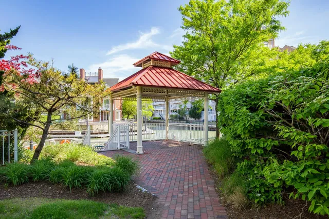 a view of a patio with table and chairs under an umbrella