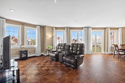 a living room with furniture large window and a table