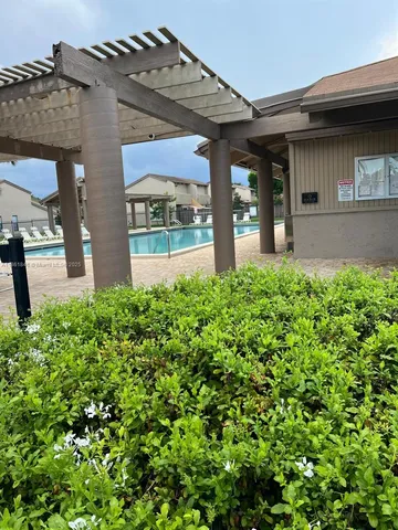 a view of a house with backyard and deck