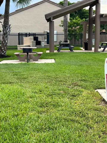 a view of backyard with swimming pool and outdoor seating