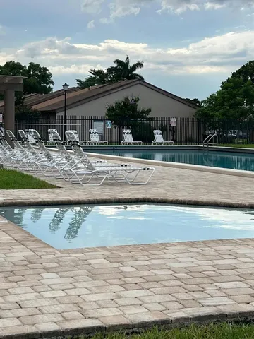 a view of a house with backyard porch and sitting area
