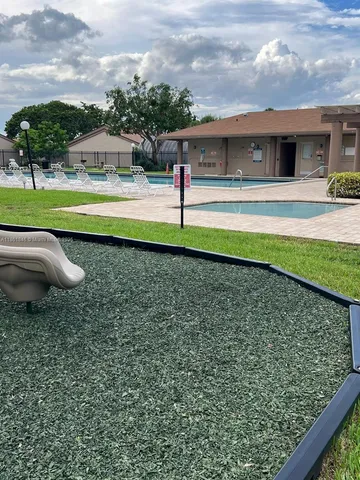 a view of a house with backyard sitting area and garden