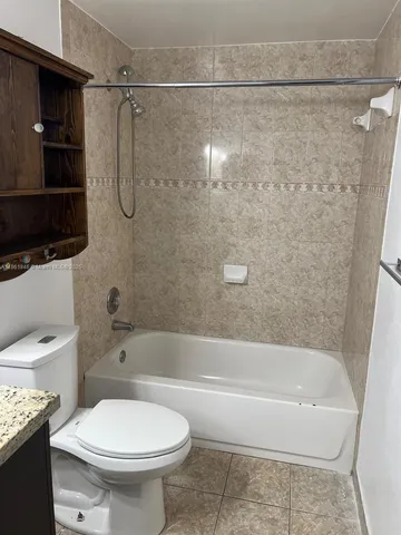 a bathroom with a toilet and a bathtub