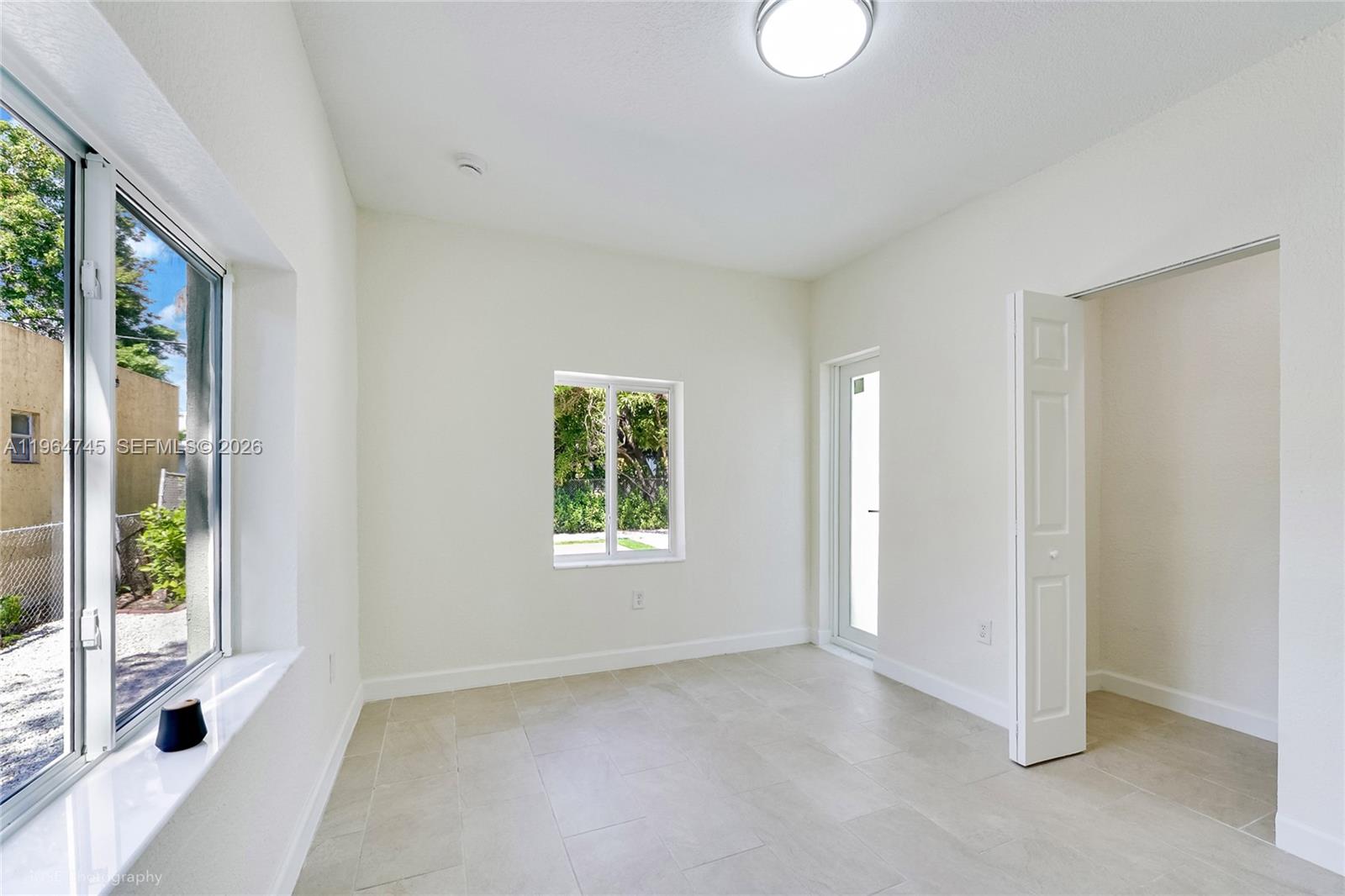 1139 Northwest 37th Street Miami, FL 33127 - Photo 20 of 27 Bedroom 2 with exit door to backyard