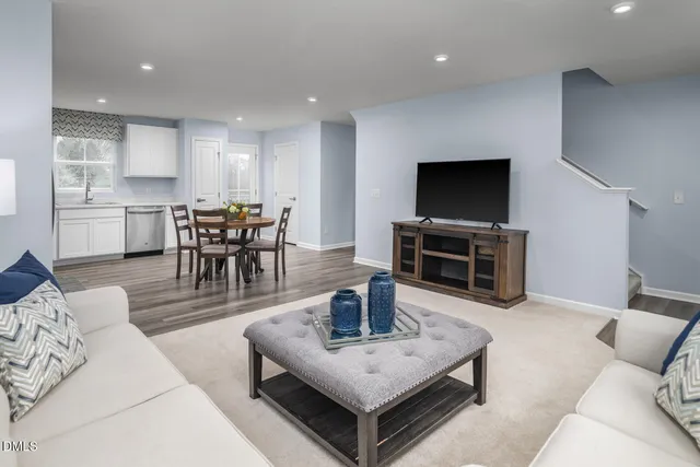 a living room with furniture and kitchen view
