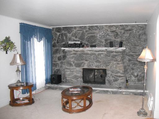 950 Black Road Joliet, IL 60435 - Photo 3 of 15 a room with a fireplace and a table