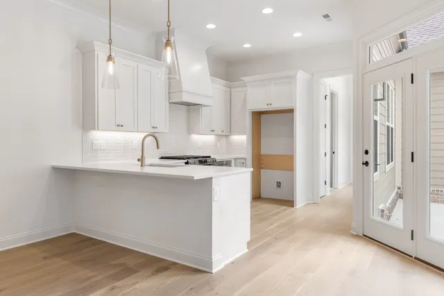 a kitchen with stainless steel appliances a refrigerator sink and cabinets