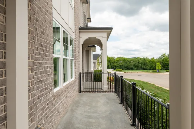 a view of a porch with furniture and garden