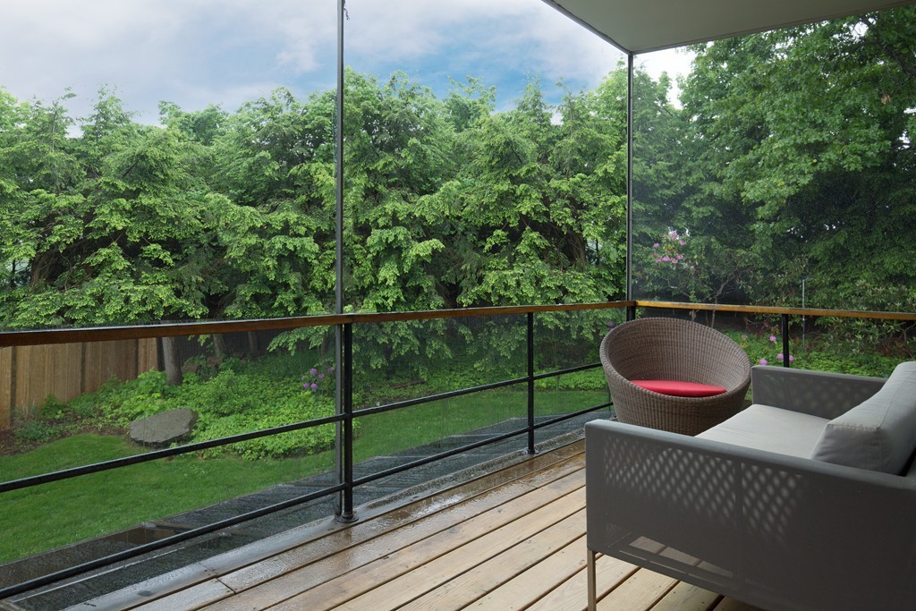 28 Barberry Road Lexington, MA 02421 - Photo 11 of 11 a balcony with a book table and chairs