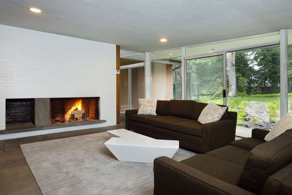 28 Barberry Road Lexington, MA 02421 - Photo 3 of 11 a living room with furniture a floor to ceiling window and a fireplace