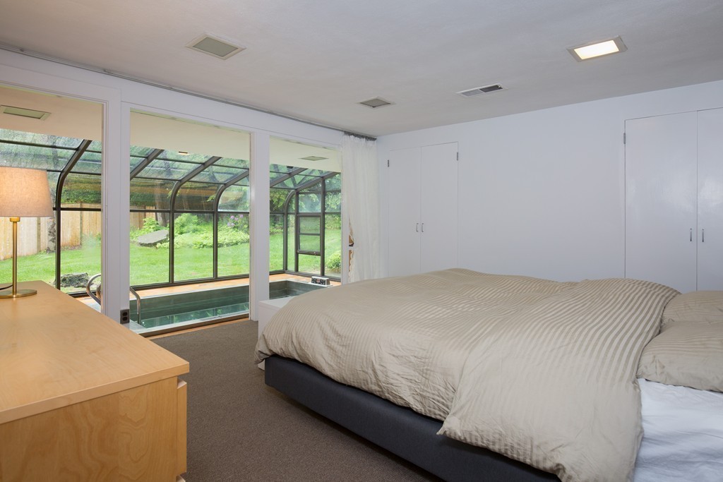28 Barberry Road Lexington, MA 02421 - Photo 8 of 11 a bed sitting in a room next to a window