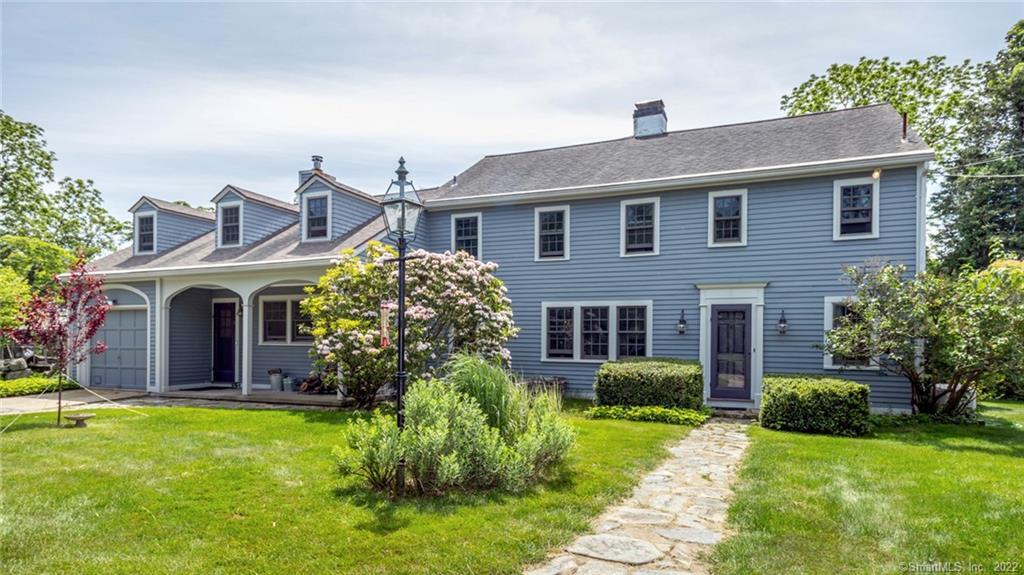 a front view of house with yard and green space