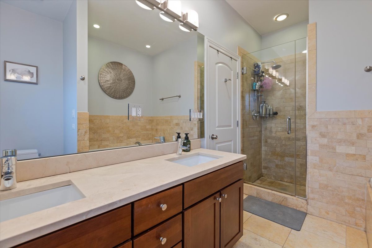 2130 West Rice Street, Unit 4 Chicago, IL 60622 - Photo 23 of 35 a bathroom with a sink a large mirror and a shower