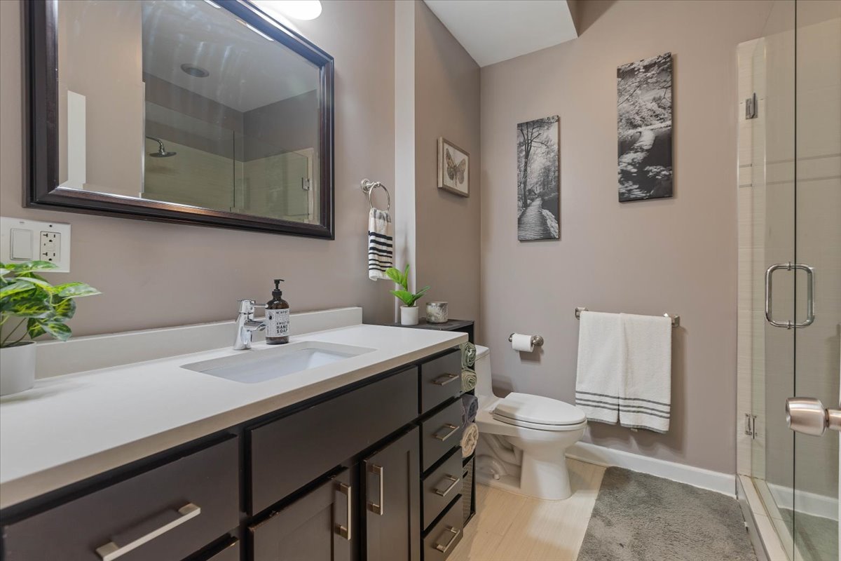 2130 West Rice Street, Unit 4 Chicago, IL 60622 - Photo 25 of 35 a bathroom with a sink a toilet and a mirror