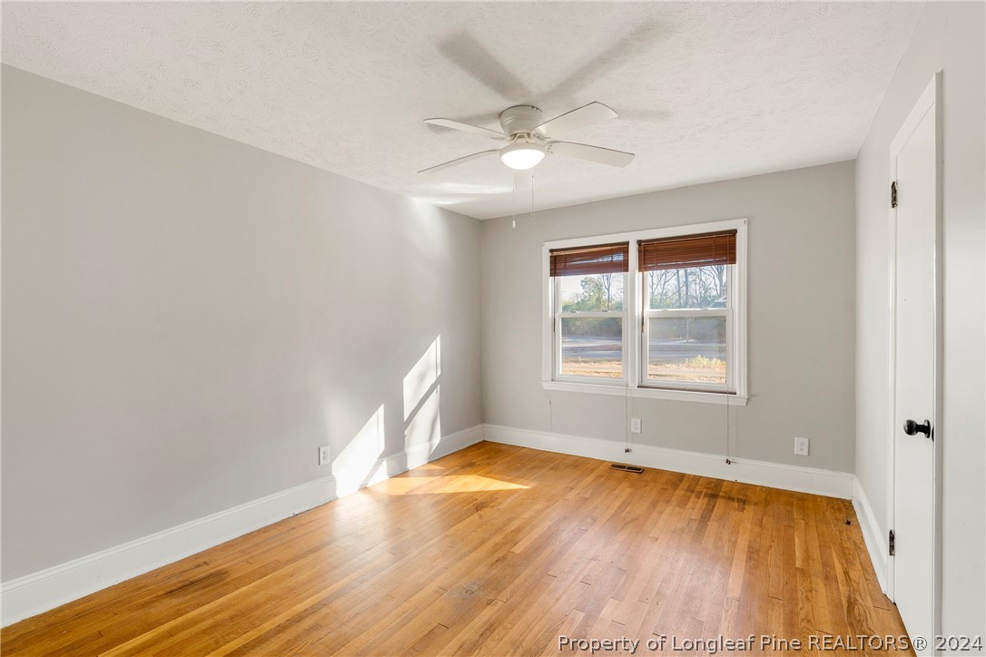 1700 Cedar Creek Road Fayetteville, NC 28312 - Photo 13 of 21 wooden floor in an empty room with a window