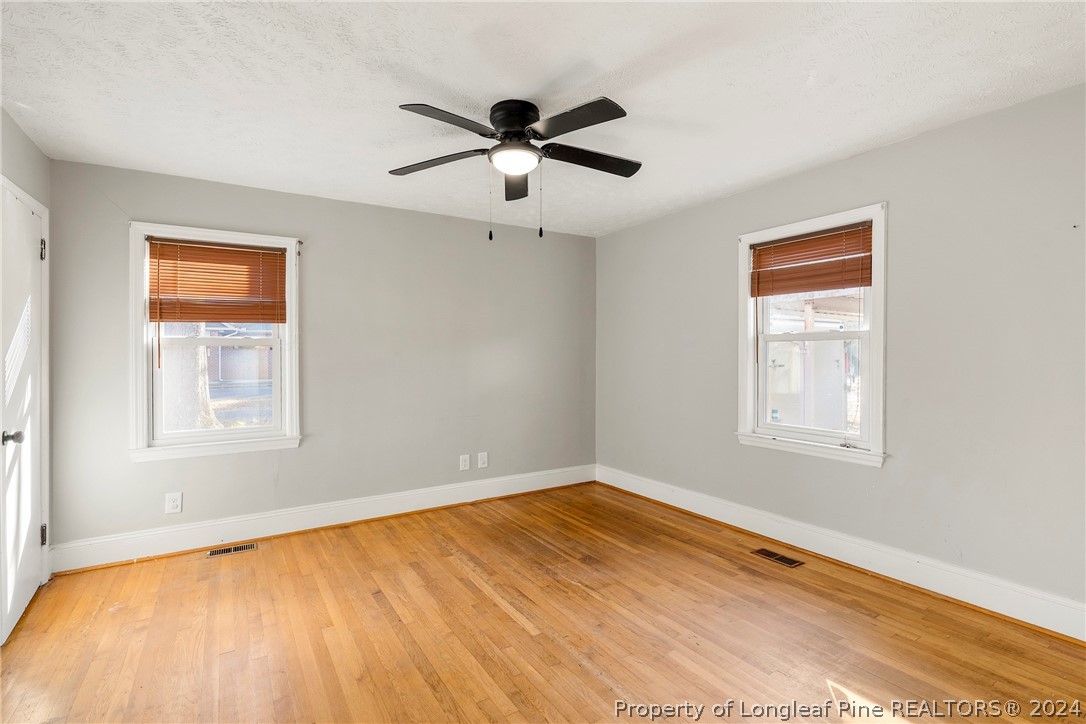 1700 Cedar Creek Road Fayetteville, NC 28312 - Photo 14 of 21 a view of empty room with wooden floor and fan