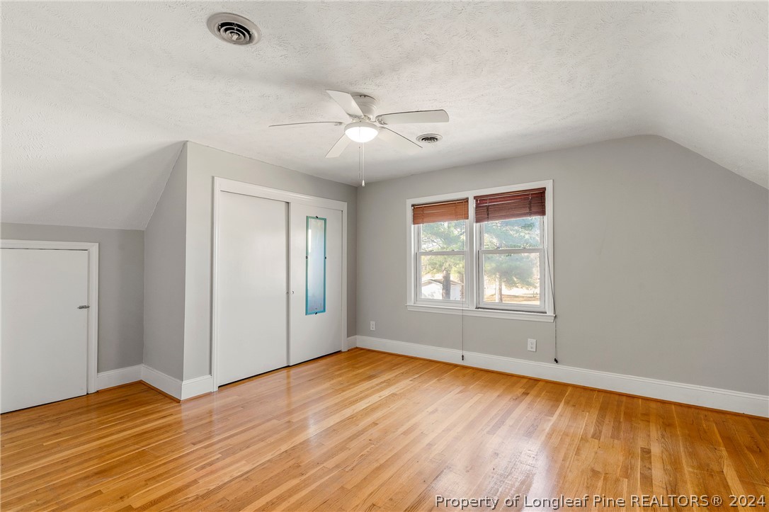 1700 Cedar Creek Road Fayetteville, NC 28312 - Photo 20 of 21 an empty room with wooden floor and windows
