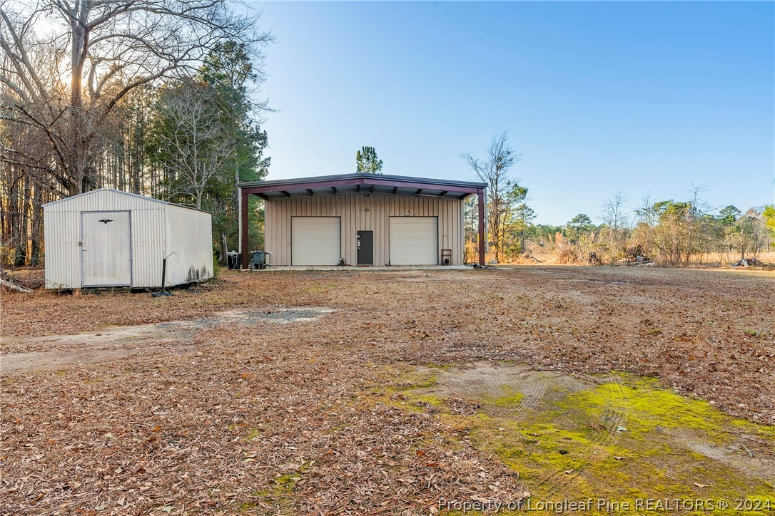 1700 Cedar Creek Road Fayetteville, NC 28312 - Photo 5 of 21 a view of a house with backyard and trees