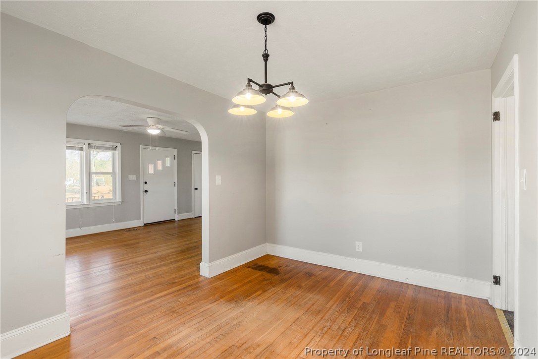 1700 Cedar Creek Road Fayetteville, NC 28312 - Photo 9 of 21 a view of empty room with wooden floor and fan