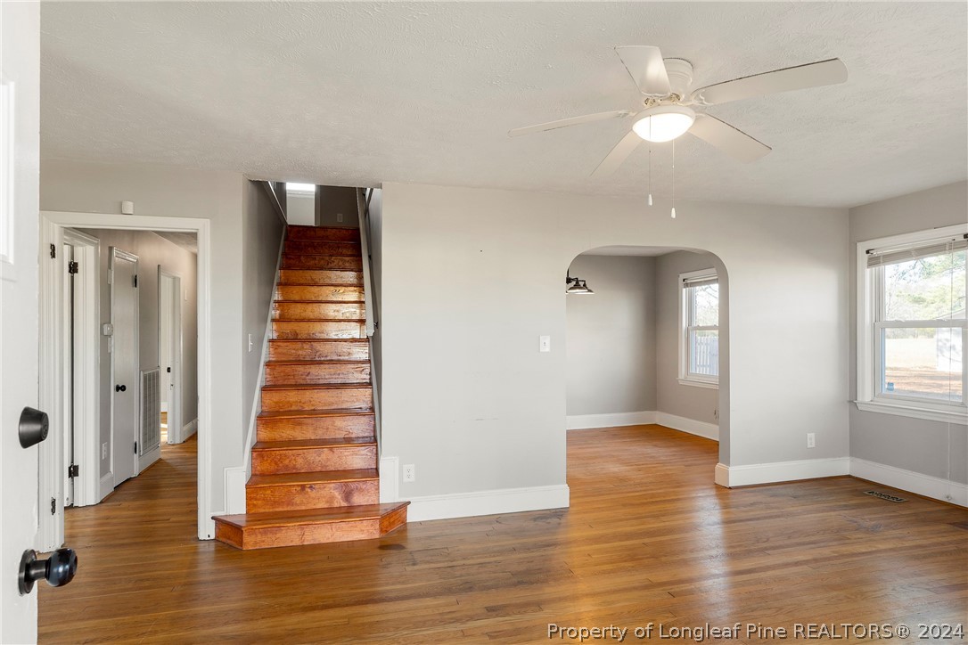 1700 Cedar Creek Road Fayetteville, NC 28312 - Photo 10 of 21 an empty room with wooden floor and windows