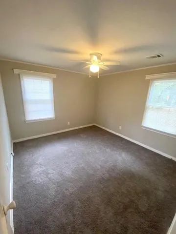 an empty room with a empty space and windows