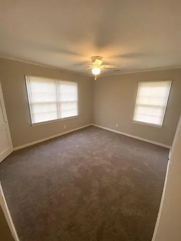 an empty room with a window and fireplace