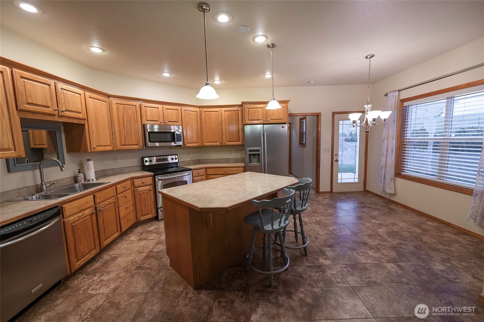6279 Touchet North Road Touchet, WA 99360 - Photo 15 of 34 a kitchen with stainless steel appliances granite countertop a stove a sink a refrigerator and a microwave