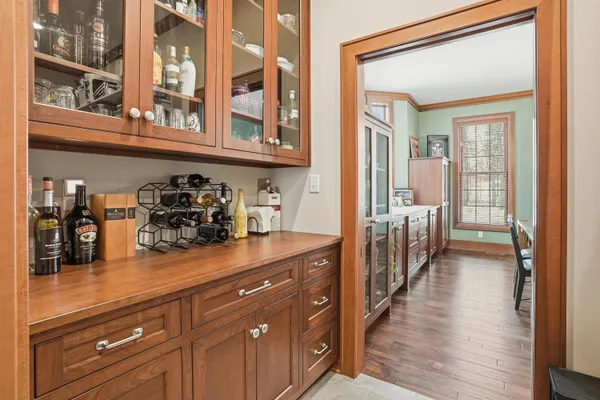 a view of a dining room with furniture large windows and wooden floor