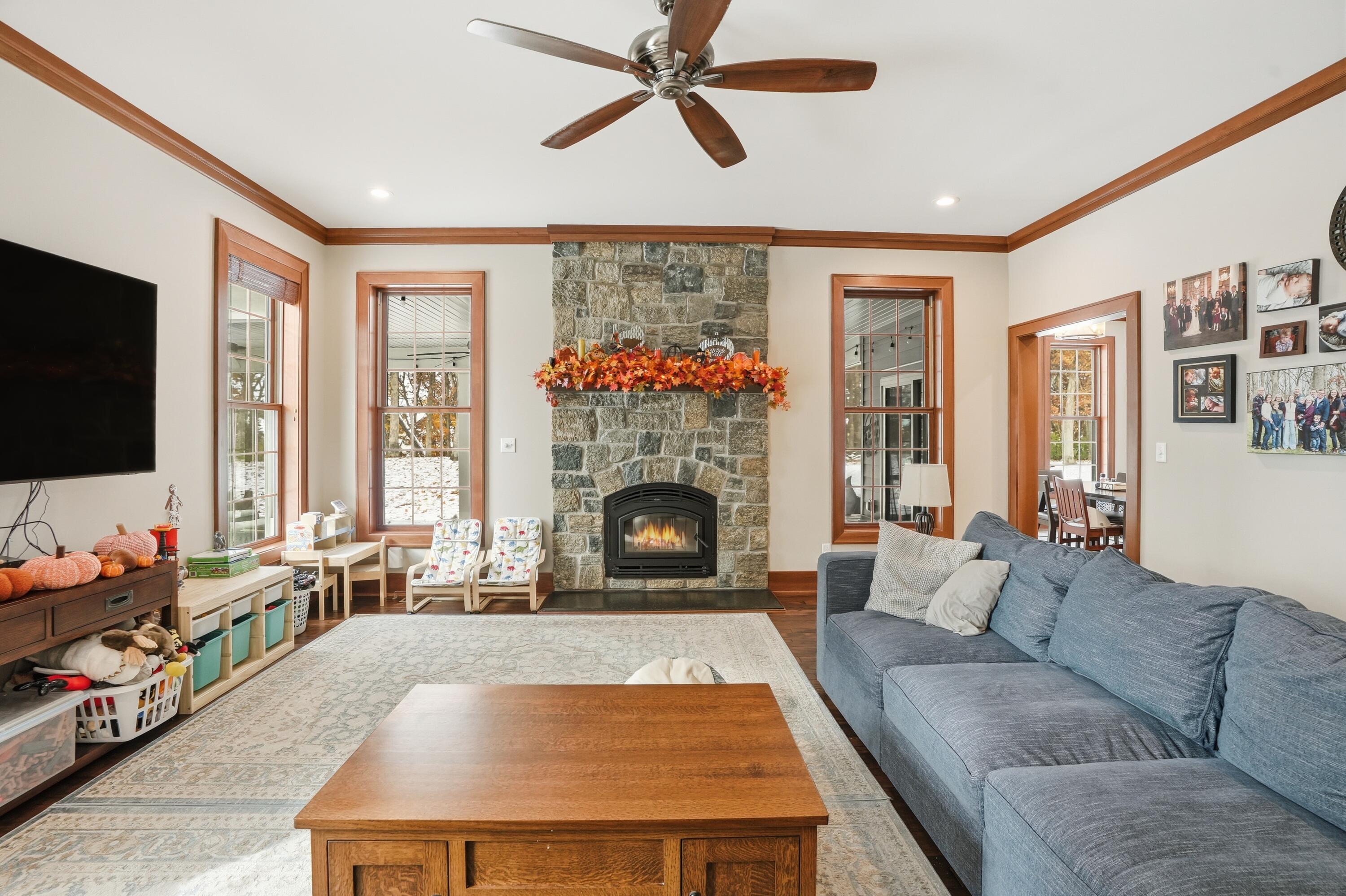804 Shannon Drive Crown Point, IN 46307 - Photo 25 of 71 a living room with furniture a flat screen tv and a fireplace