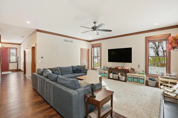 a view of a hallway with wooden floor and staircase