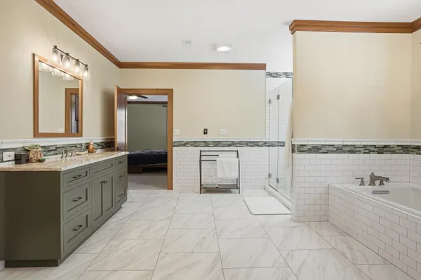 a bathroom with a granite countertop sink a toilet and shower