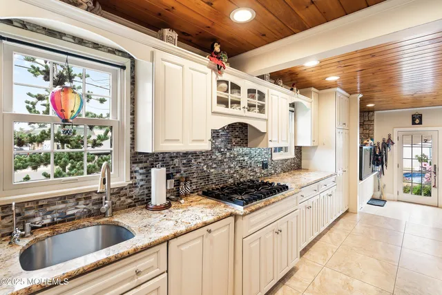 a kitchen with stainless steel appliances granite countertop a sink stove and a granite counter top