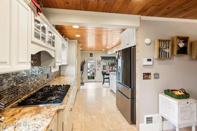 a kitchen with stainless steel appliances granite countertop a refrigerator and a stove
